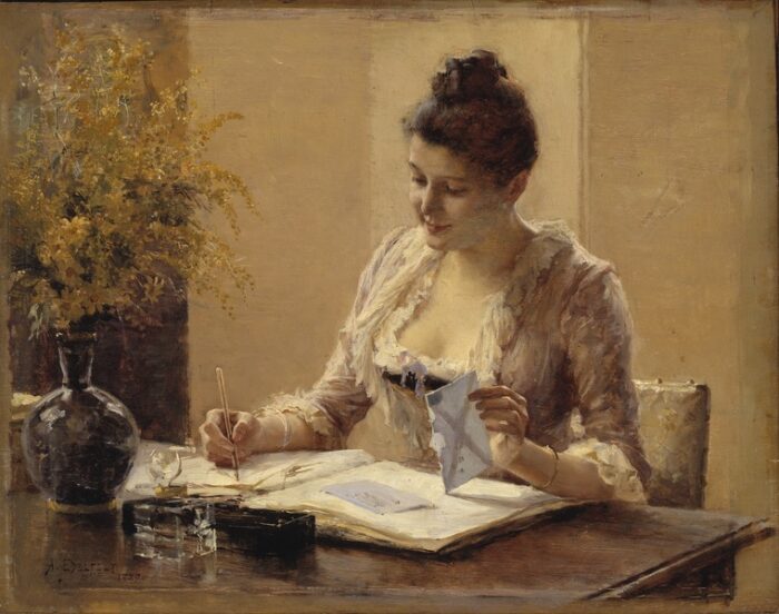  A woman in a late nineteenth century dress and hairstyle, sitting at a table with an envelope in her left hand and a pen in her right.